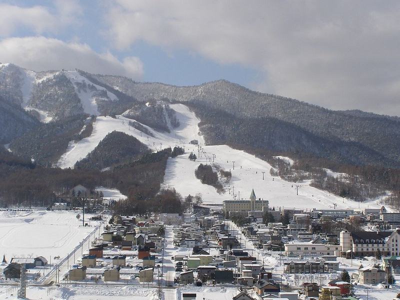 Furano ski area rising behind the town in winter
